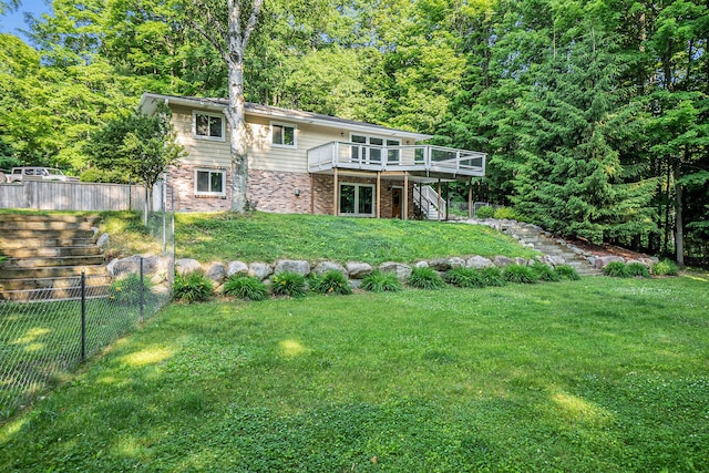 15770 157th Ave, Big Rapids, MI 49307 - back of property featuring brick siding, stairs, a wooden deck, and a wooded view