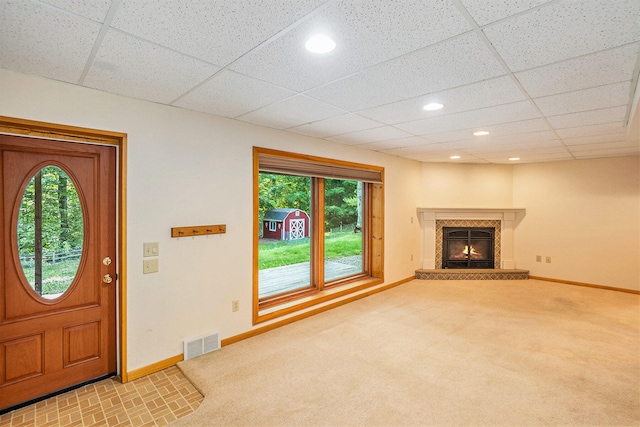 15770 157th Ave, Big Rapids, MI 49307 - entrance foyer with healthy amount of natural light, a lit fireplace, a paneled ceiling, carpet, and recessed lighting