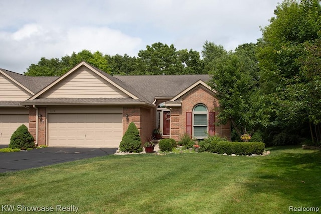 1128 Eagle Nest Dr, Milford, MI 48381 - single story home featuring a garage, brick siding, asphalt driveway, a front lawn, and a shingled roof