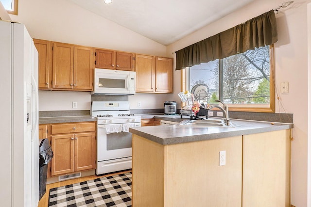 5767 E Grove Dr SE, Kentwood, MI 49512 - kitchen with white appliances, lofted ceiling, a peninsula, and dark countertops
