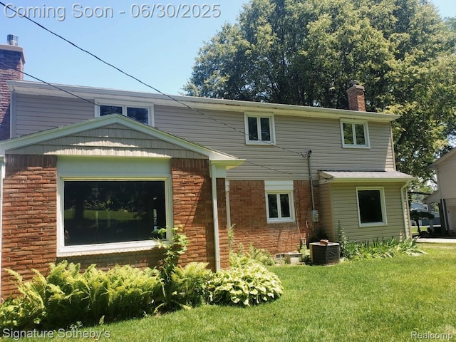 2200 Brenthaven Dr E, Bloomfield, MI 48304 - rear view of house featuring a chimney, a lawn, and brick siding