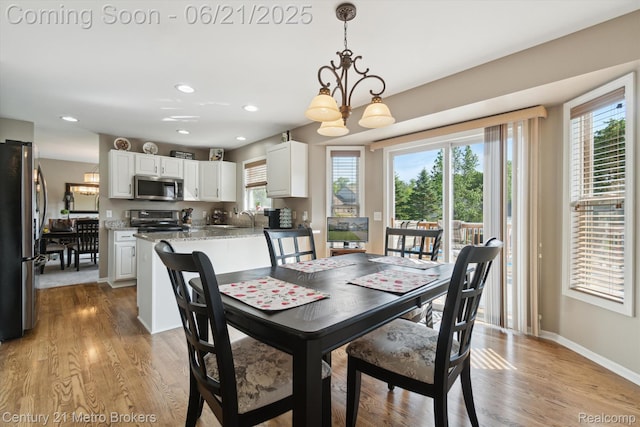 9145 Woodridge Dr, Davison, MI 48423 - dining room with healthy amount of natural light, a chandelier, light wood-style flooring, and recessed lighting