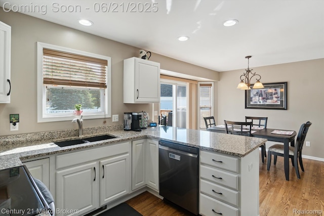 9145 Woodridge Dr, Davison, MI 48423 - kitchen with stainless steel appliances, a peninsula, wood finished floors, healthy amount of natural light, and recessed lighting