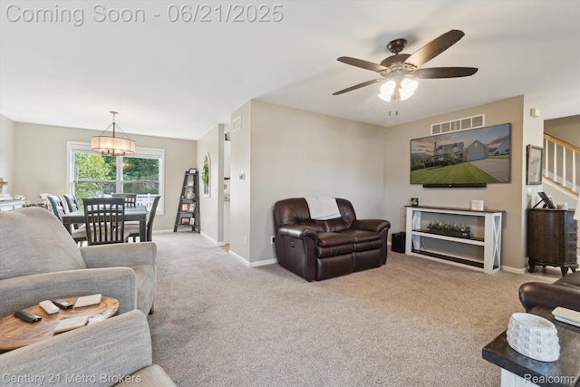 9145 Woodridge Dr, Davison, MI 48423 - living room featuring carpet floors, ceiling fan, and stairs