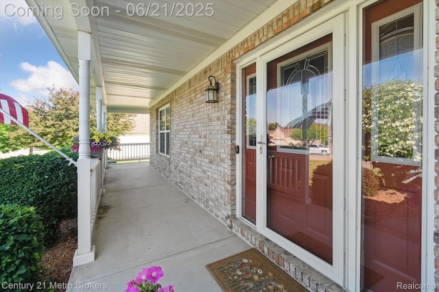 9145 Woodridge Dr, Davison, MI 48423 - doorway to property with a porch and brick siding