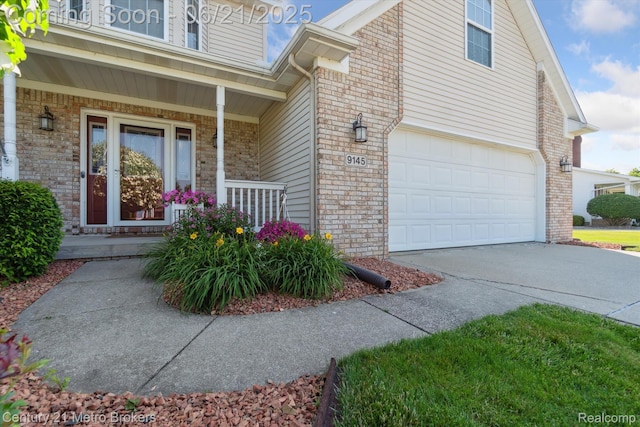 9145 Woodridge Dr, Davison, MI 48423 - view of side of home with a porch, brick siding, driveway, and an attached garage