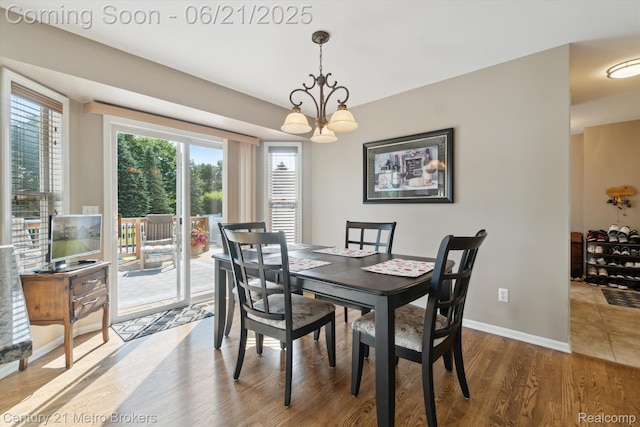 9145 Woodridge Dr, Davison, MI 48423 - dining space featuring a chandelier and wood finished floors