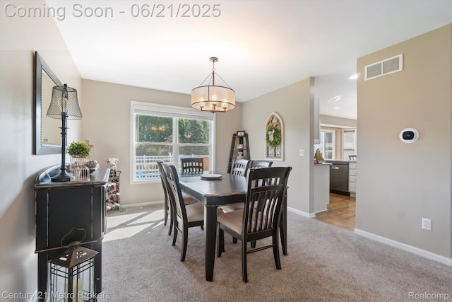 9145 Woodridge Dr, Davison, MI 48423 - dining area featuring light colored carpet, plenty of natural light, and a chandelier