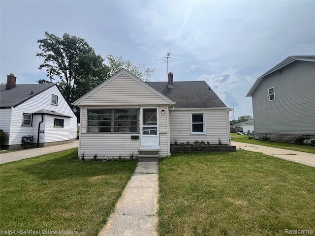 25616 Hoffmeyer St, Roseville, MI 48066 - bungalow-style house with a front lawn, a chimney, roof with shingles, and entry steps