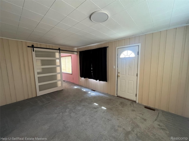 25616 Hoffmeyer St, Roseville, MI 48066 - carpeted foyer entrance with healthy amount of natural light, a barn door, and wood walls