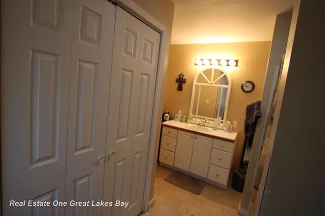 1521 Stanley St, Saginaw, MI 48602 - bathroom featuring a closet, vanity, and a shower with door