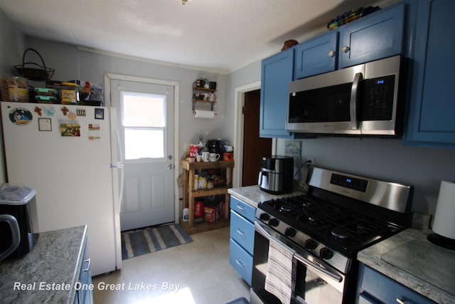 1521 Stanley St, Saginaw, MI 48602 - kitchen featuring stainless steel appliances, blue cabinets, and light floors