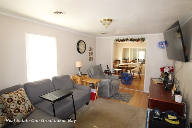 1521 Stanley St, Saginaw, MI 48602 - living area featuring wood finished floors and ornamental molding