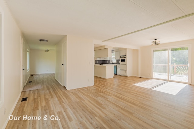 838 S Grey Rd, Midland, MI 48640 - unfurnished living room featuring light wood finished floors and baseboards