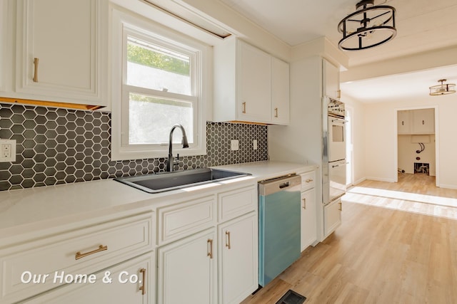 838 S Grey Rd, Midland, MI 48640 - kitchen featuring dishwashing machine, light wood-style flooring, decorative backsplash, and white cabinetry