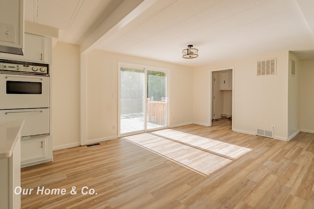 838 S Grey Rd, Midland, MI 48640 - unfurnished dining area featuring light wood-type flooring and baseboards