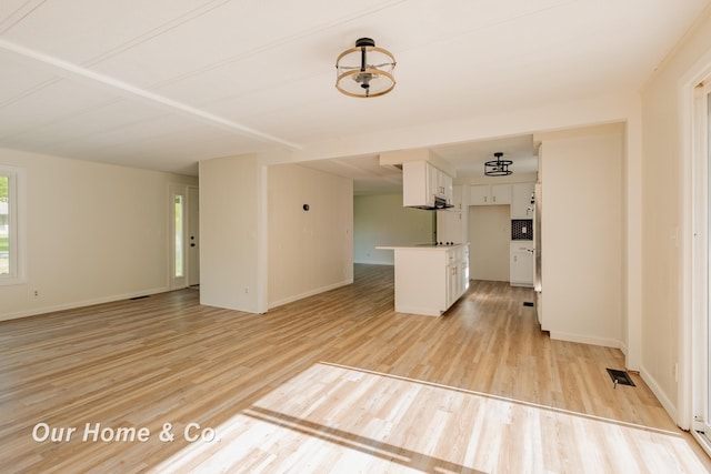 838 S Grey Rd, Midland, MI 48640 - unfurnished living room featuring light wood-type flooring