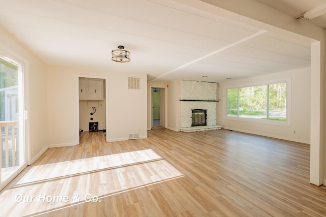 838 S Grey Rd, Midland, MI 48640 - unfurnished living room with light wood-style flooring and a fireplace