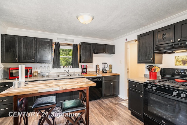 5430 N Center Rd, Saginaw, MI 48604 - kitchen with black appliances, butcher block countertops, under cabinet range hood, dark cabinetry, and a textured ceiling