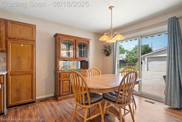 37862 Parkhurst St, Livonia, MI 48154 - dining area with a chandelier and light wood-style flooring