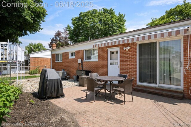 37862 Parkhurst St, Livonia, MI 48154 - back of property with brick siding, a patio area, and outdoor dining area