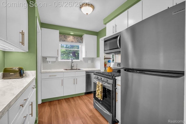 2734 Vassar St, Dearborn, MI 48124 - kitchen with stainless steel appliances, plenty of natural light, light wood finished floors, and light countertops