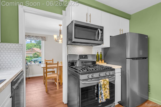 2734 Vassar St, Dearborn, MI 48124 - kitchen with appliances with stainless steel finishes, light countertops, tasteful backsplash, and white cabinetry