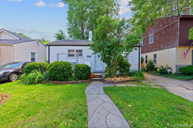 11228 Hudson Ave, Warren, MI 48089 - view of front of house with a front lawn and a chimney