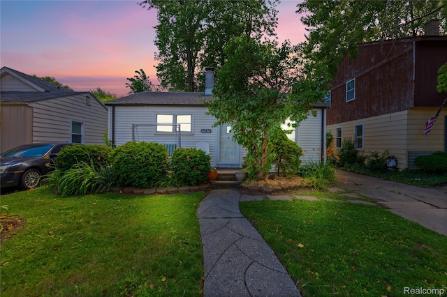 11228 Hudson Ave, Warren, MI 48089 - view of front of house featuring a front yard, a chimney, and entry steps