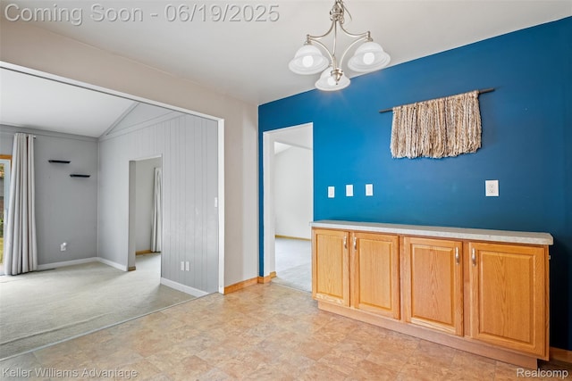 14000 Ellen Dr, Livonia, MI 48154 - empty room featuring light carpet, vaulted ceiling, and a chandelier