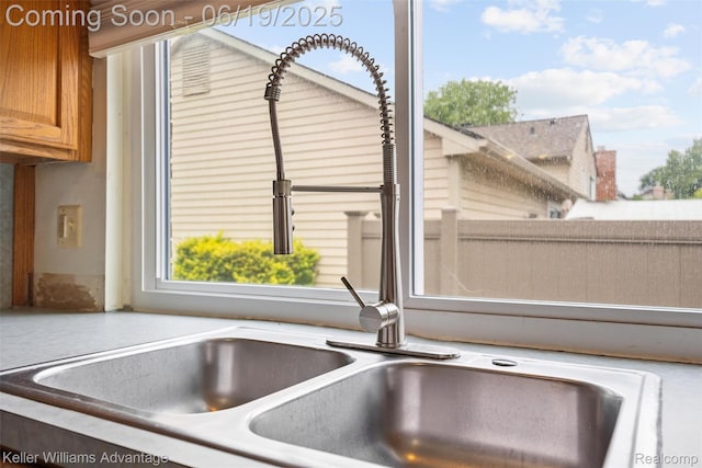 14000 Ellen Dr, Livonia, MI 48154 - kitchen view of a sink and brown cabinetry