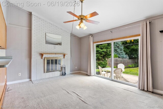 14000 Ellen Dr, Livonia, MI 48154 - unfurnished living room featuring vaulted ceiling, carpet floors, a ceiling fan, and a brick fireplace