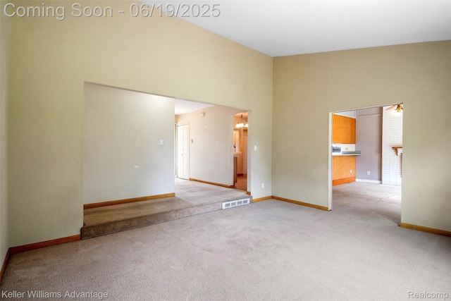 14000 Ellen Dr, Livonia, MI 48154 - spare room featuring light colored carpet and a towering ceiling