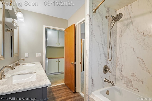 14000 Ellen Dr, Livonia, MI 48154 - bathroom featuring a combined bath / shower with marble appearance, double vanity, and wood finished floors