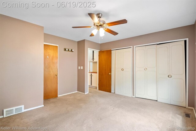 14000 Ellen Dr, Livonia, MI 48154 - unfurnished bedroom featuring carpet flooring, multiple closets, and ceiling fan
