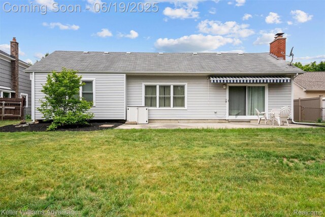 14000 Ellen Dr, Livonia, MI 48154 - back of house with roof with shingles, a patio area, and a chimney