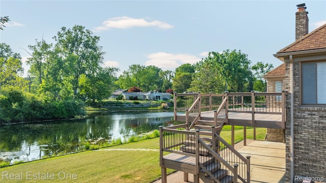 52615 Seven Oaks Dr, Shelby Twp, MI 48316 - view of grassy yard featuring stairs and a deck with water view