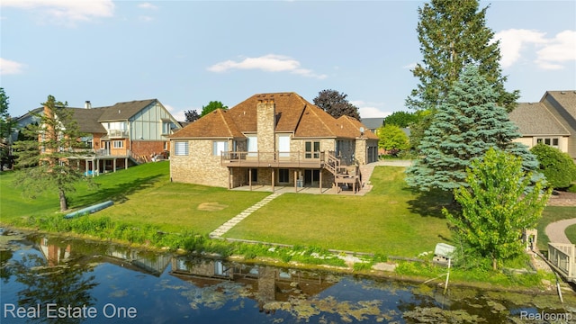 52615 Seven Oaks Dr, Shelby Twp, MI 48316 - rear view of house with a deck with water view, a lawn, a patio area, stone siding, and stairway