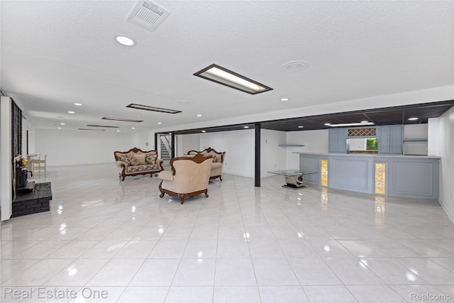 52615 Seven Oaks Dr, Shelby Twp, MI 48316 - living area featuring light tile patterned floors, a textured ceiling, and recessed lighting