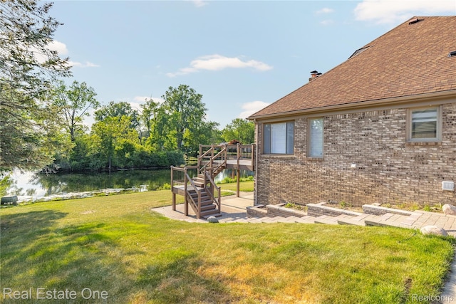 52615 Seven Oaks Dr, Shelby Twp, MI 48316 - view of green lawn with stairway and a deck with water view