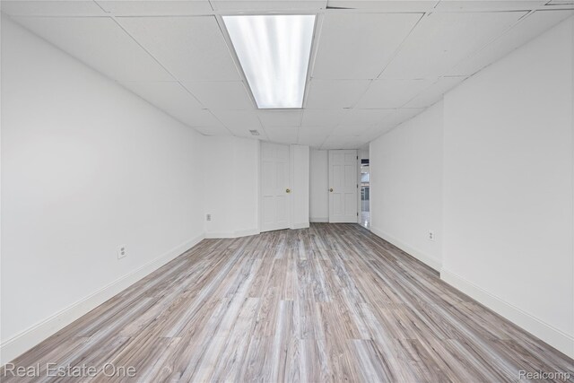 52615 Seven Oaks Dr, Shelby Twp, MI 48316 - finished below grade area with a paneled ceiling and light wood-style floors