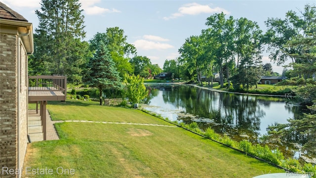 52615 Seven Oaks Dr, Shelby Twp, MI 48316 - view of green lawn featuring a deck with water view