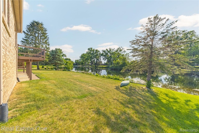 52615 Seven Oaks Dr, Shelby Twp, MI 48316 - view of green lawn with a deck with water view