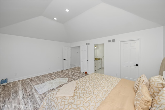 52615 Seven Oaks Dr, Shelby Twp, MI 48316 - bedroom with vaulted ceiling, wood finished floors, recessed lighting, and ensuite bath