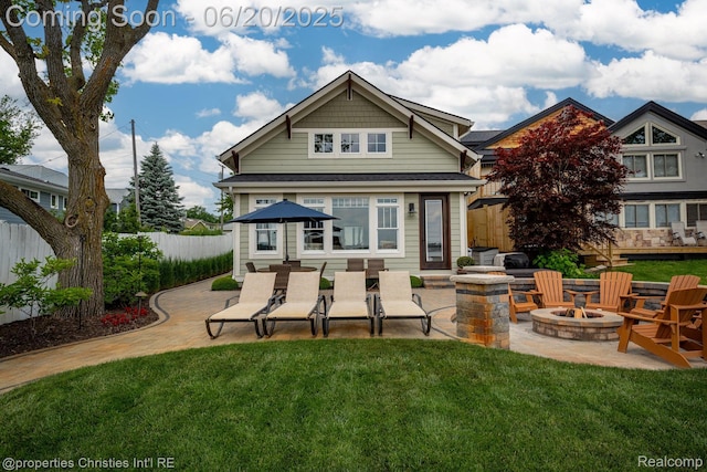 11693 Kenton Dr, Whitmore Lake, MI 48189 - rear view of house featuring an outdoor fire pit and a patio area