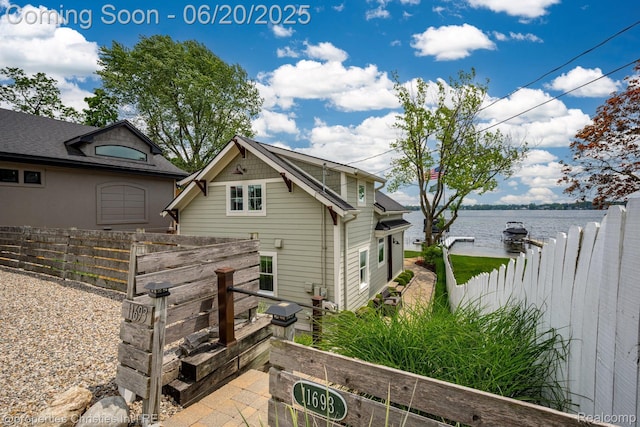 11693 Kenton Dr, Whitmore Lake, MI 48189 - rear view of house with a water view