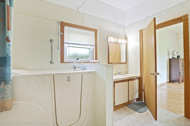 5490 Rupprecht Rd, Vassar, MI 48768 - bathroom featuring vanity, a tub, and tile patterned floors