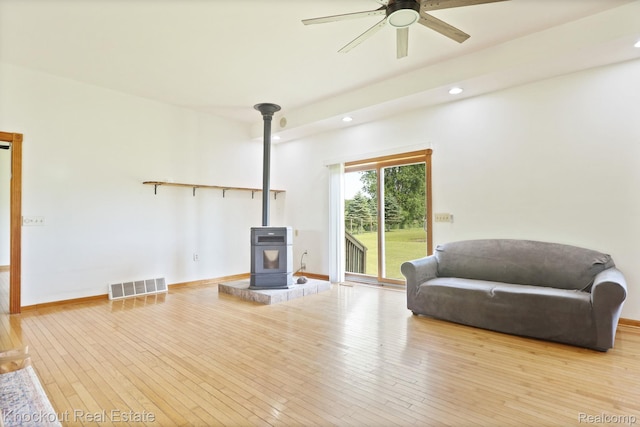 5490 Rupprecht Rd, Vassar, MI 48768 - sitting room with a wood stove, recessed lighting, ceiling fan, and hardwood / wood-style floors