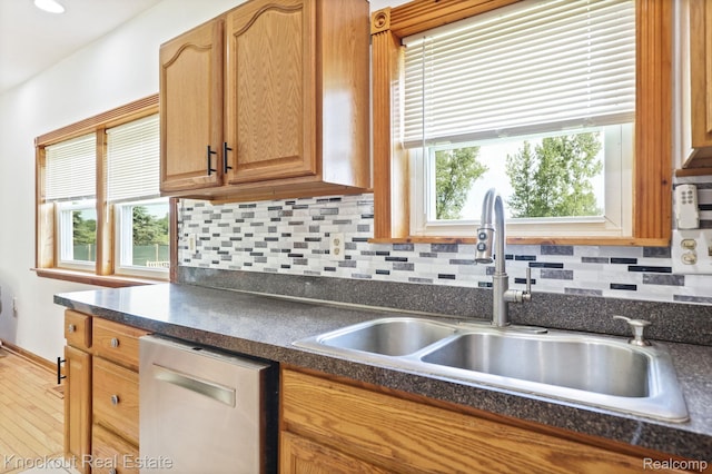 5490 Rupprecht Rd, Vassar, MI 48768 - kitchen with stainless steel dishwasher, dark countertops, tasteful backsplash, and wood finished floors