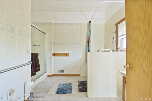 5490 Rupprecht Rd, Vassar, MI 48768 - full bath with an enclosed shower, tile patterned flooring, vanity, and tile walls